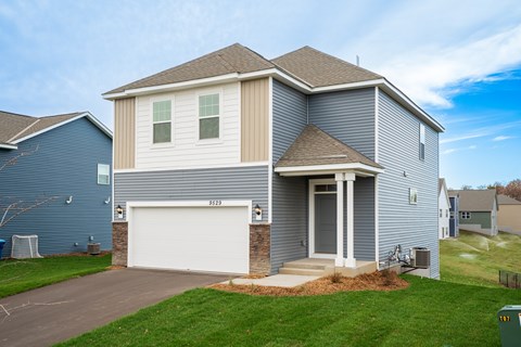 A house with a white garage door and a grey roof.